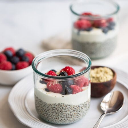 vanilla chia seed pudding topped with berries in a glass.