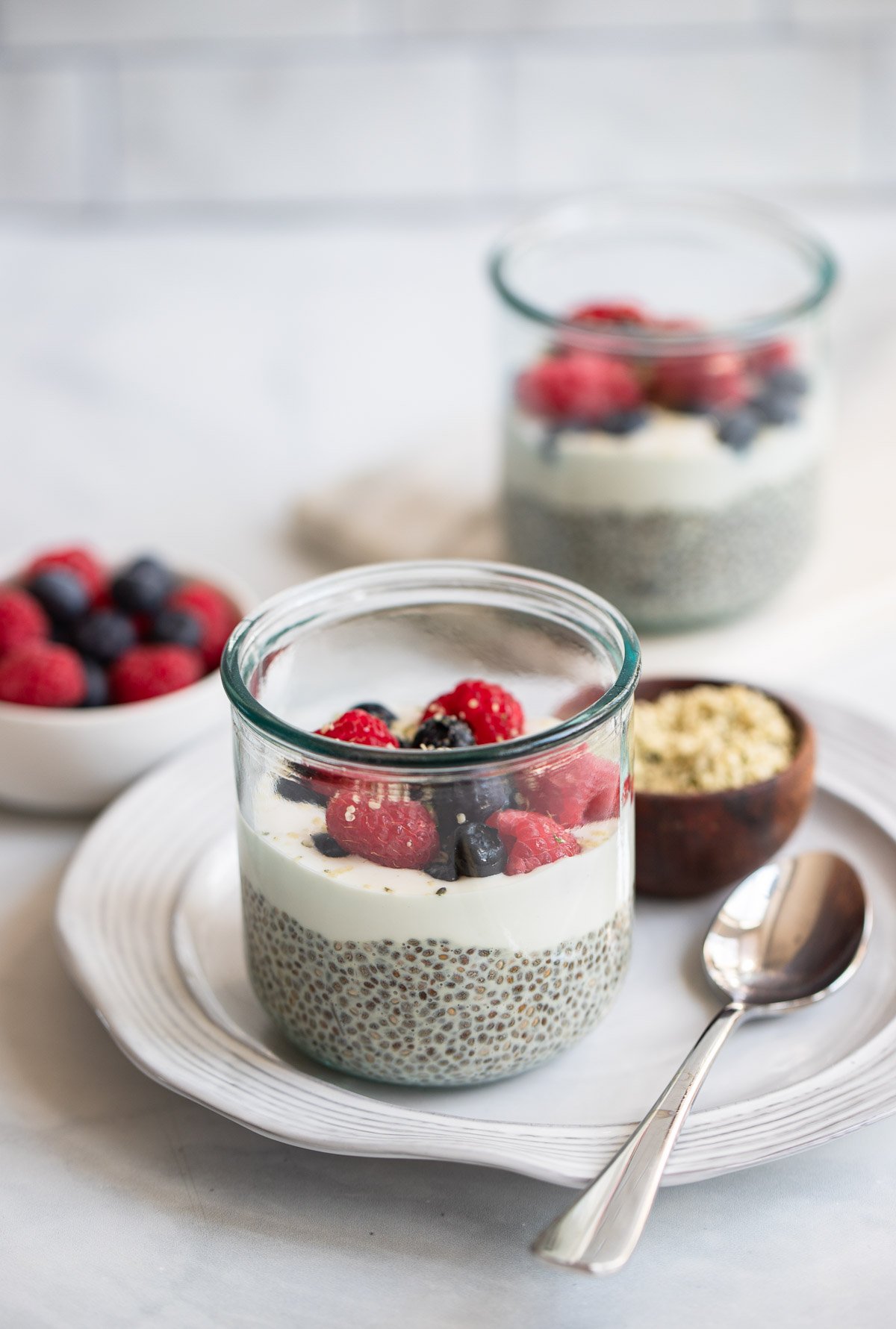 vanilla chia seed pudding topped with berries in a glass.