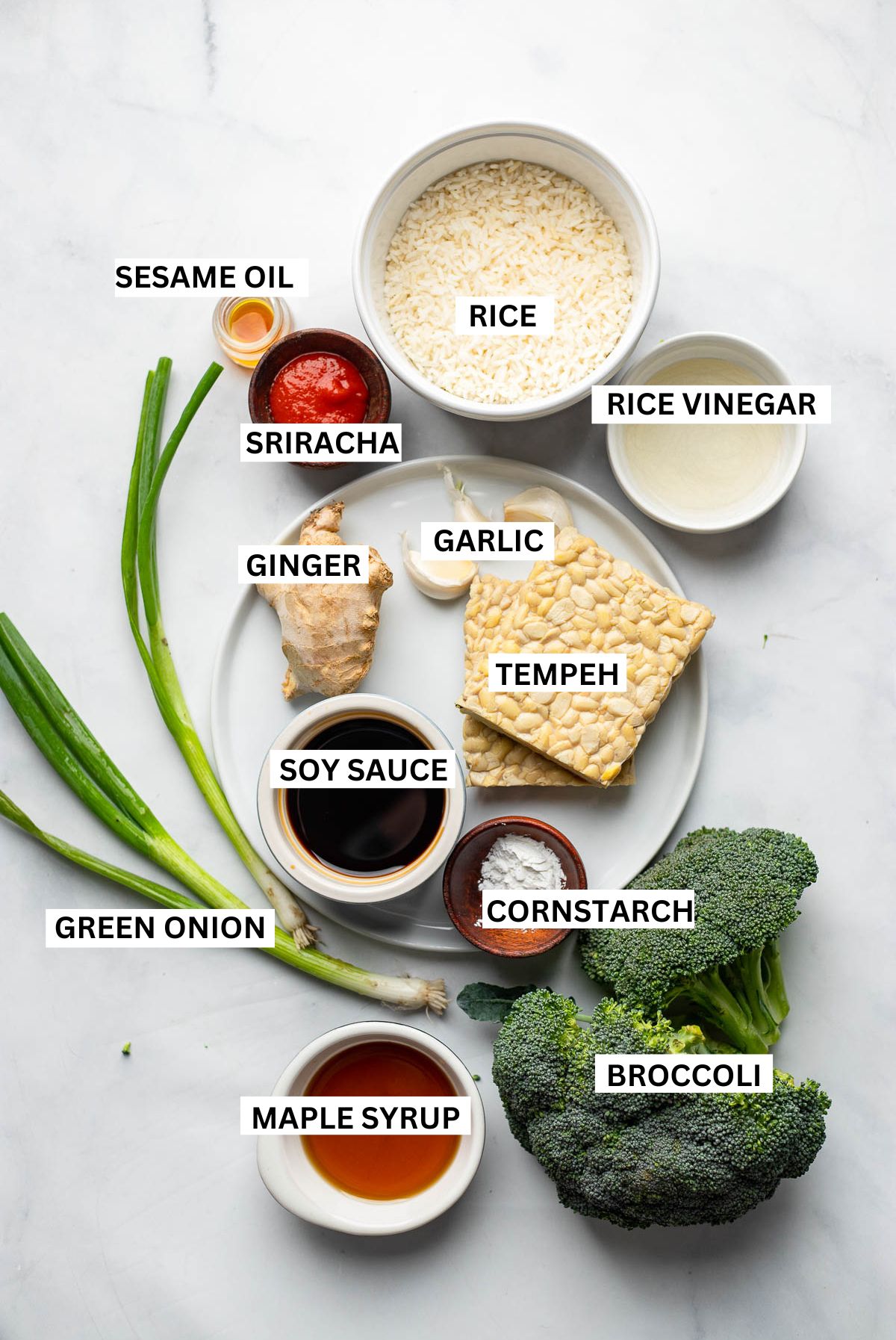 sticky tempeh bowl ingredients in small dishes with text labels on a white background. 
