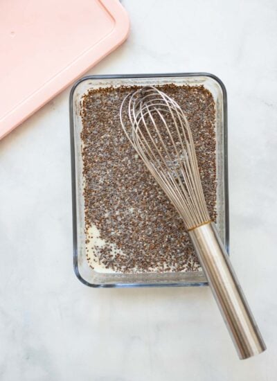 chia seed ingredients in a storage container with a whisk. 