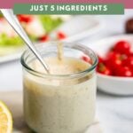 Tahini Caesar dressing in a glass jar with a spoon.