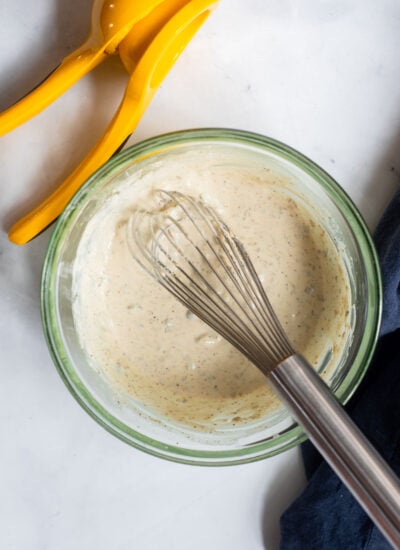 Tahini Caesar dressing whisked together in a mixing bowl. 