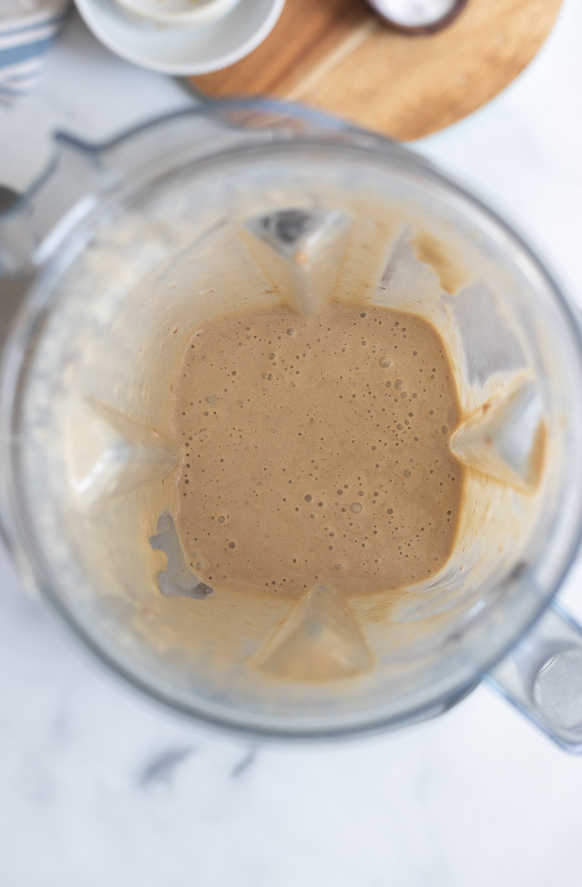 pureed tahini smoothie with dates in a blender pitcher. 