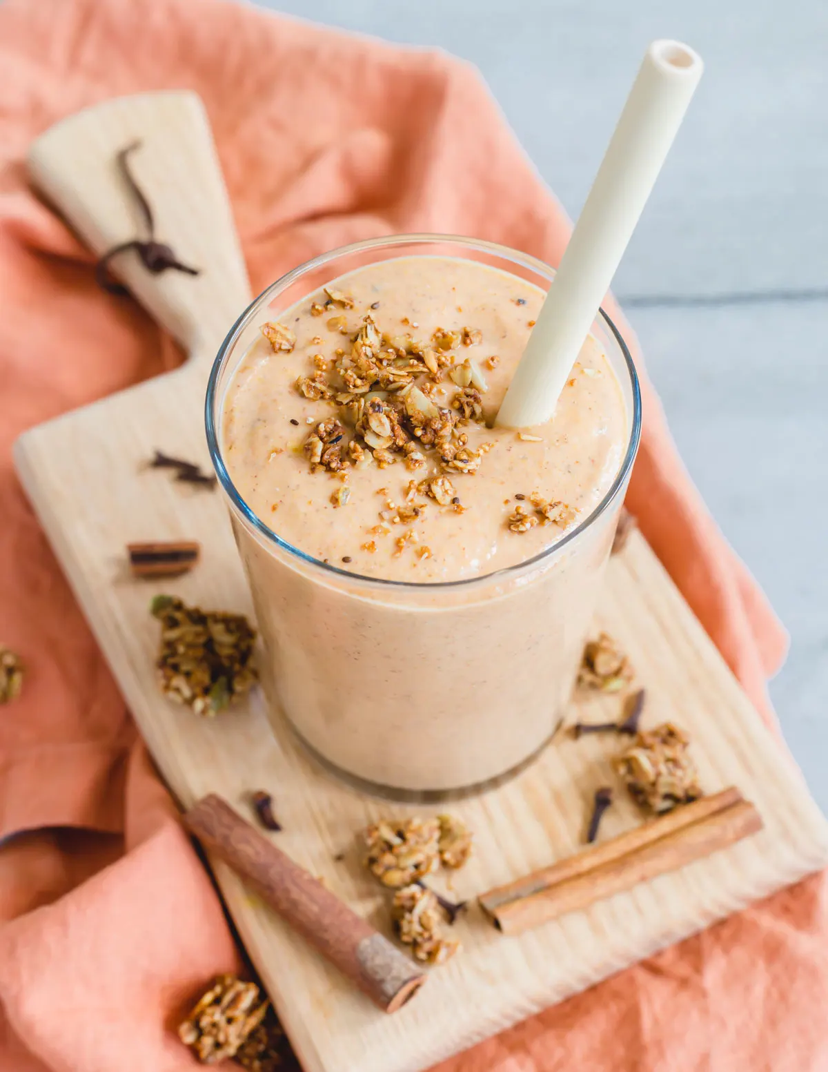 butternut squash smoothie in a glass topped with granola.