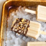 close up of peanut butter banana popsicle dipped in chocolate.