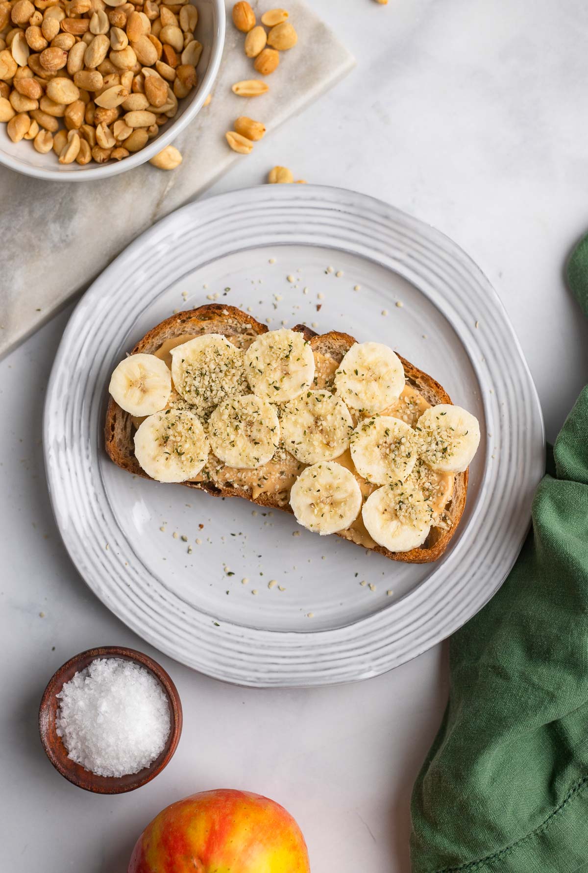 sourdough toast topped with homemade peanut butter and sliced bananas. 