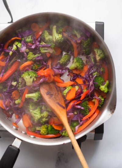 cooked stir fry vegetables in a skillet. 