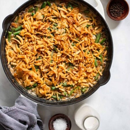 vegan green bean casserole in a skillet with a napkin.