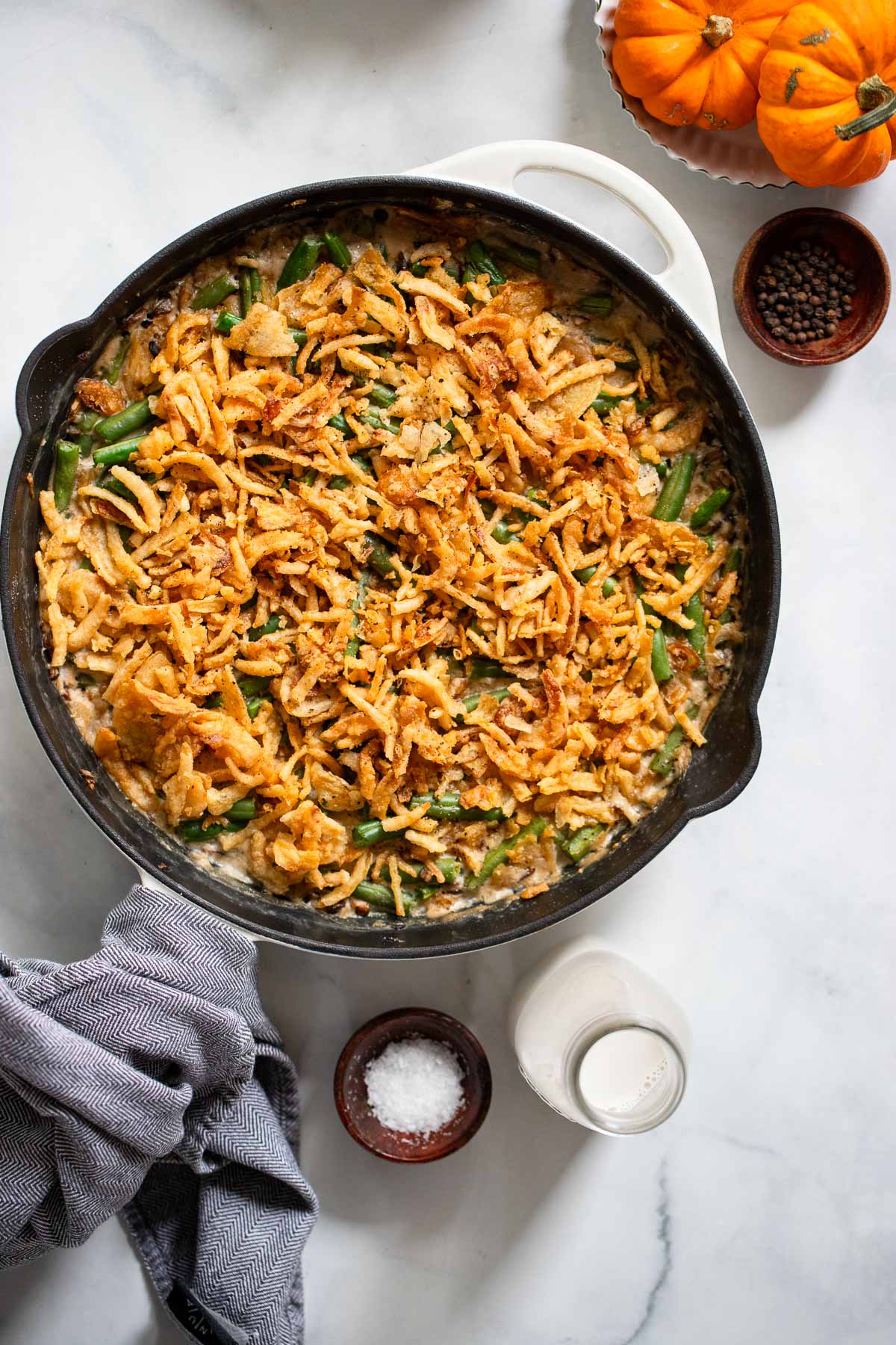 vegan green bean casserole in a skillet with a napkin.
