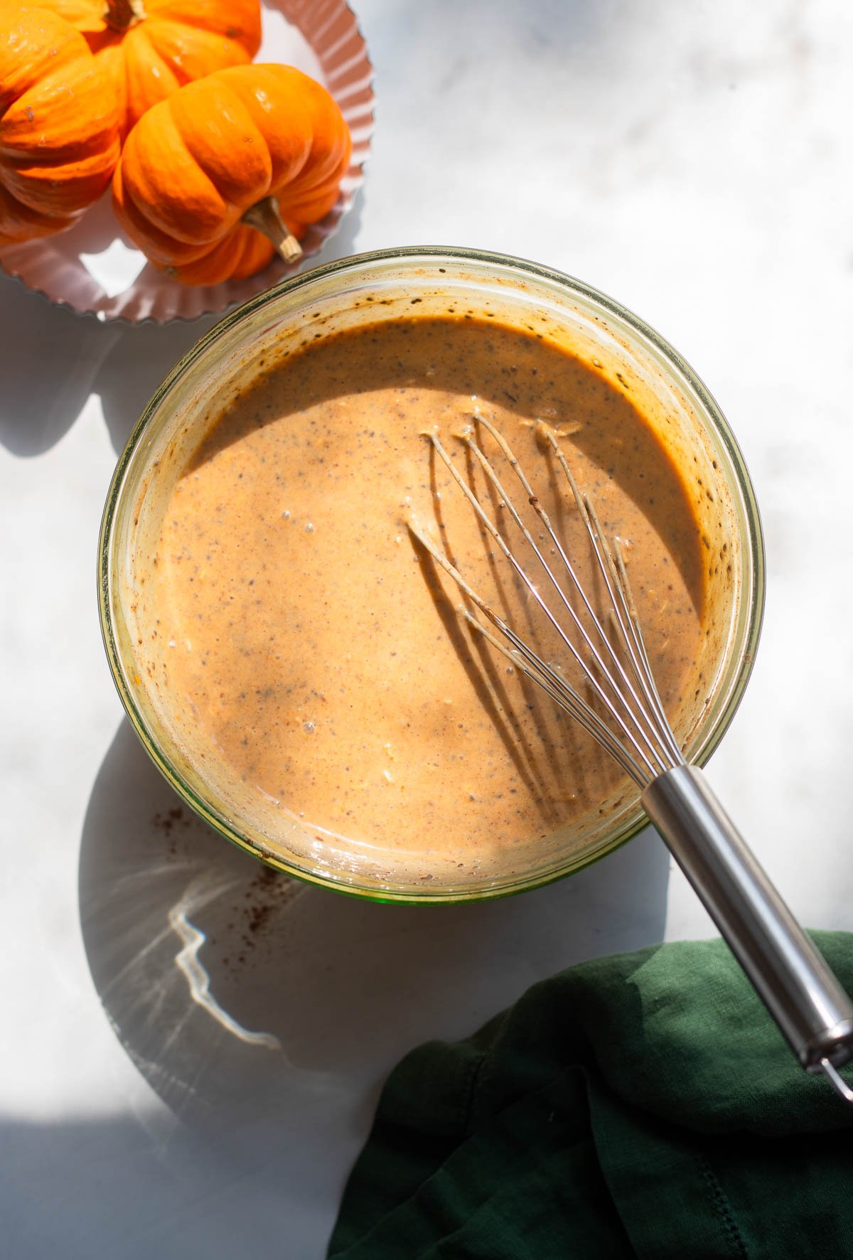 vegan pumpkin pie overnight oat ingredients whisked together in a mixing bowl.