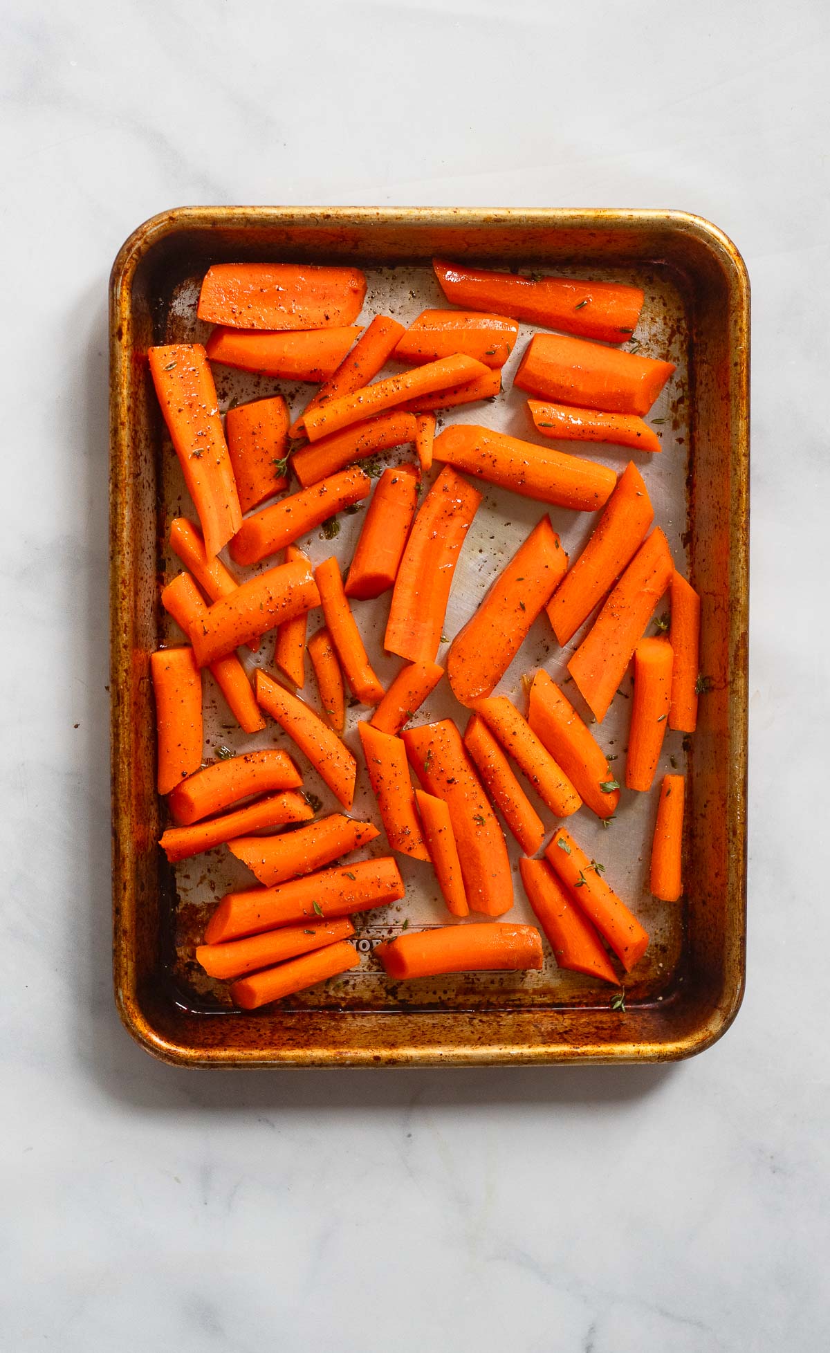 prepped carrots on a baking sheet before baking. 