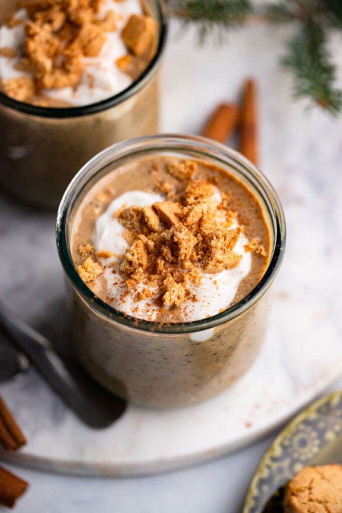 prepared gingerbread overnight oatmeal in a glass jar topped with crumbled cookies. 