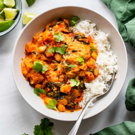 sweet potato peanut curry in a bowl with rice.