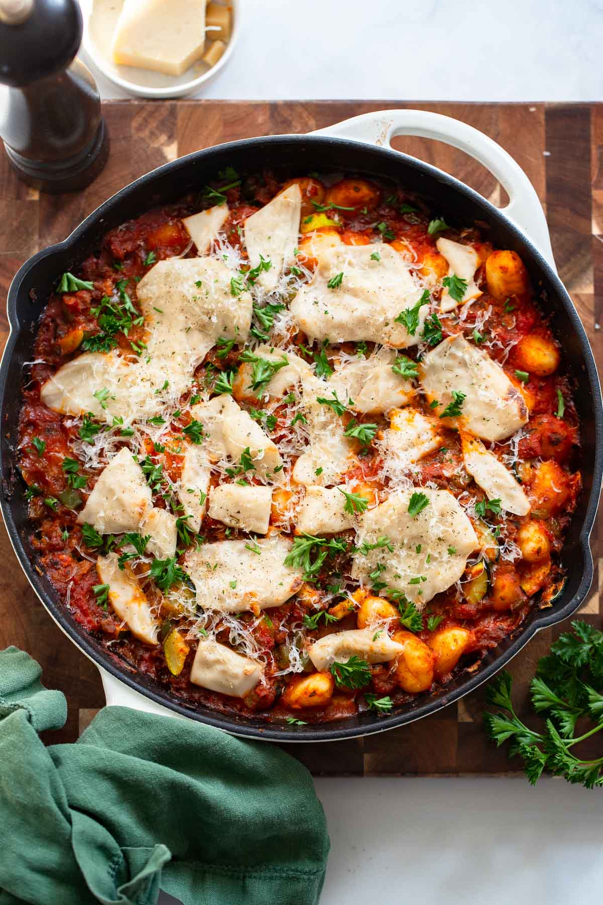 gnocchi cooked in marinara and topped with sliced mozzarella in a skillet.