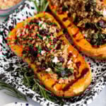 farro stuffed butternut squash halves in a tray for serving.