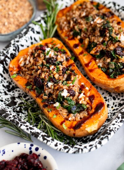 farro stuffed butternut squash halves in a tray for serving.