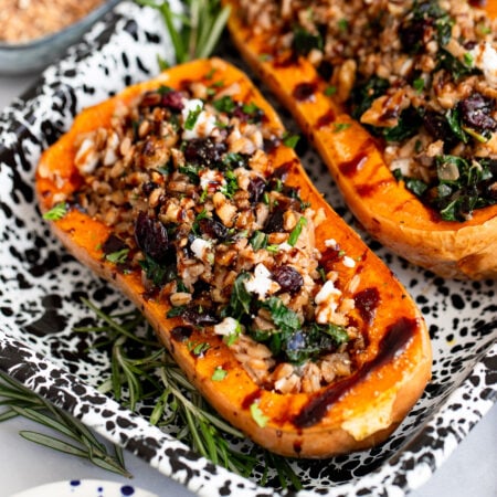 farro stuffed butternut squash halves in a tray for serving.
