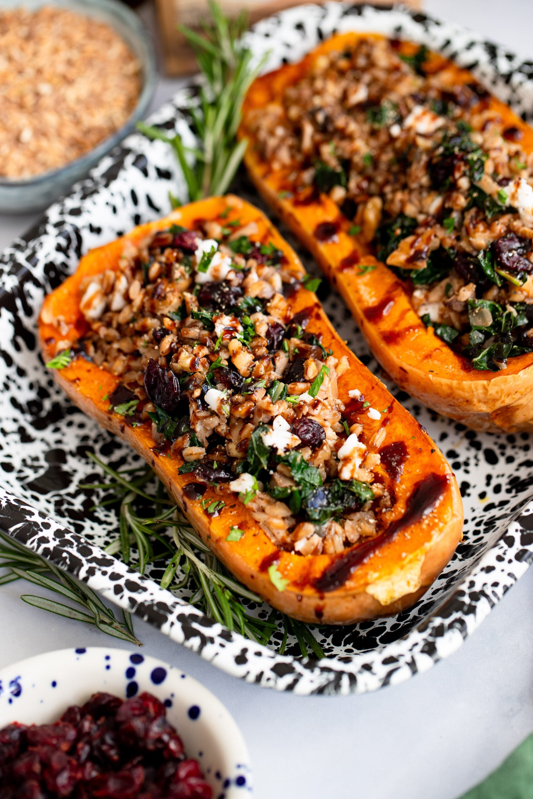 farro stuffed butternut squash halves in a tray for serving.