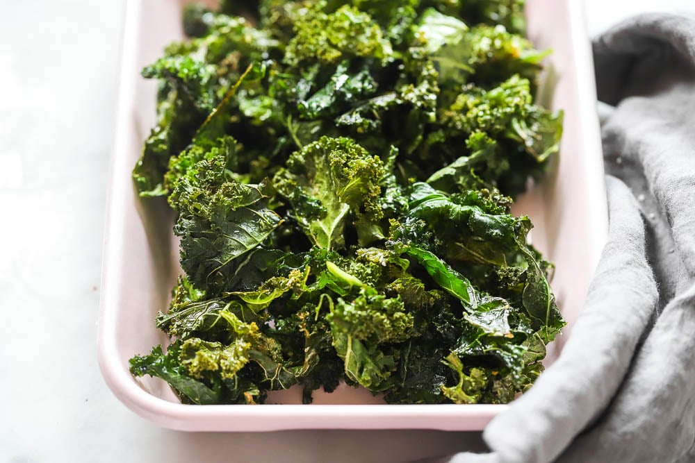 oven baked kale chips in a pink tray for serving. 