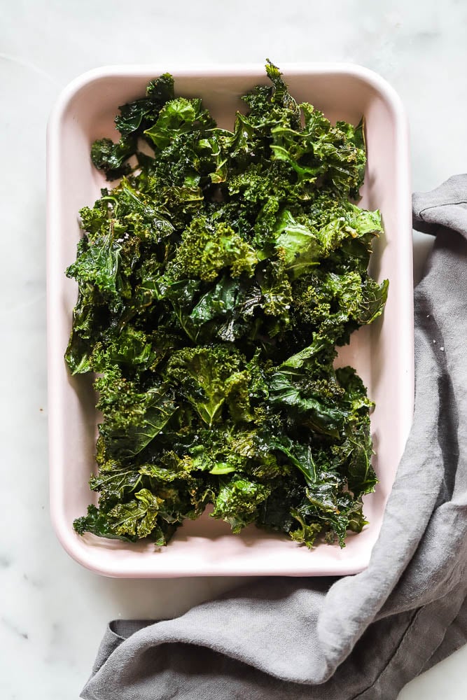 oven baked kale chips in a pink tray for serving. 