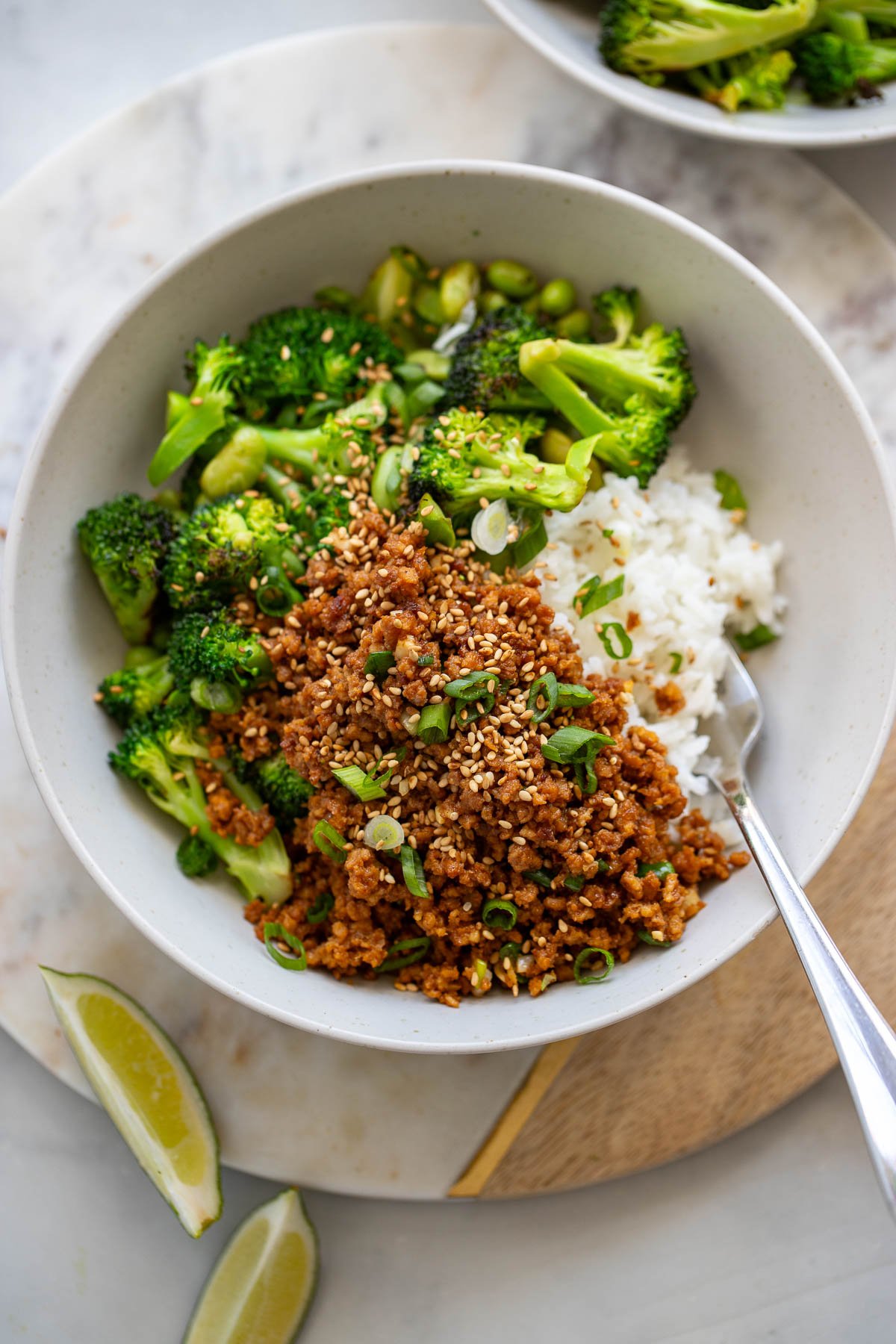 single serving of vegan beef and broccoli in a bowl garnished with sesame seeds.