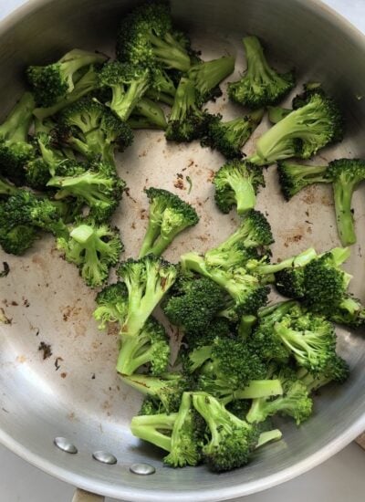 broccoli stir fried in a skillet. 