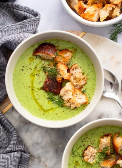 creamy celery soup in a bowl garnished with croutons.