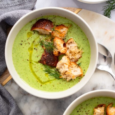 creamy celery soup in a bowl garnished with croutons.