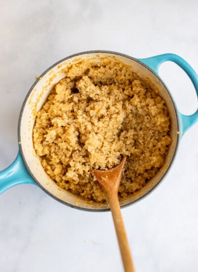 cooked quinoa in a small saucepan with a wooden spoon. 