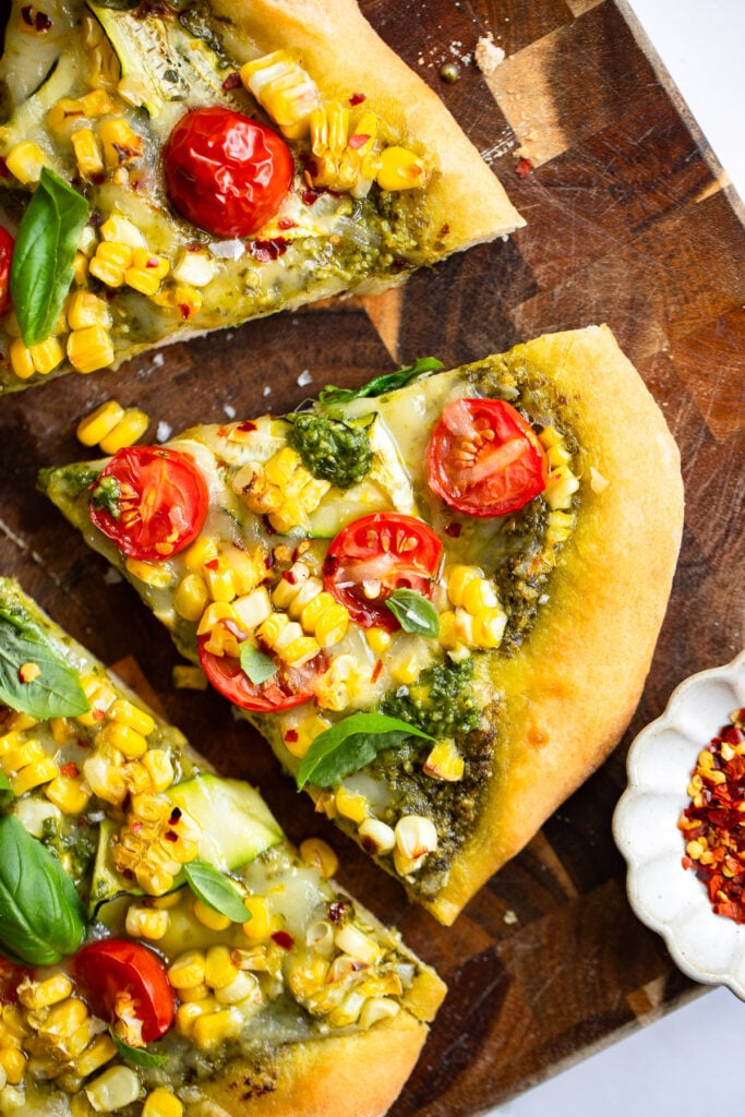 close up of a slice of sweet corn pizza.