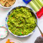 green goddess salad in bowl with crackers and celery