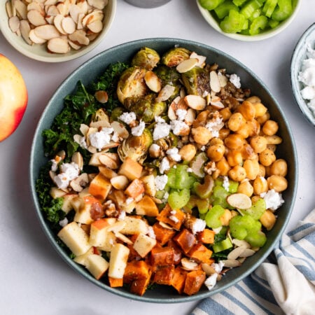harvest bowl topped with feta cheese, apples, and celery