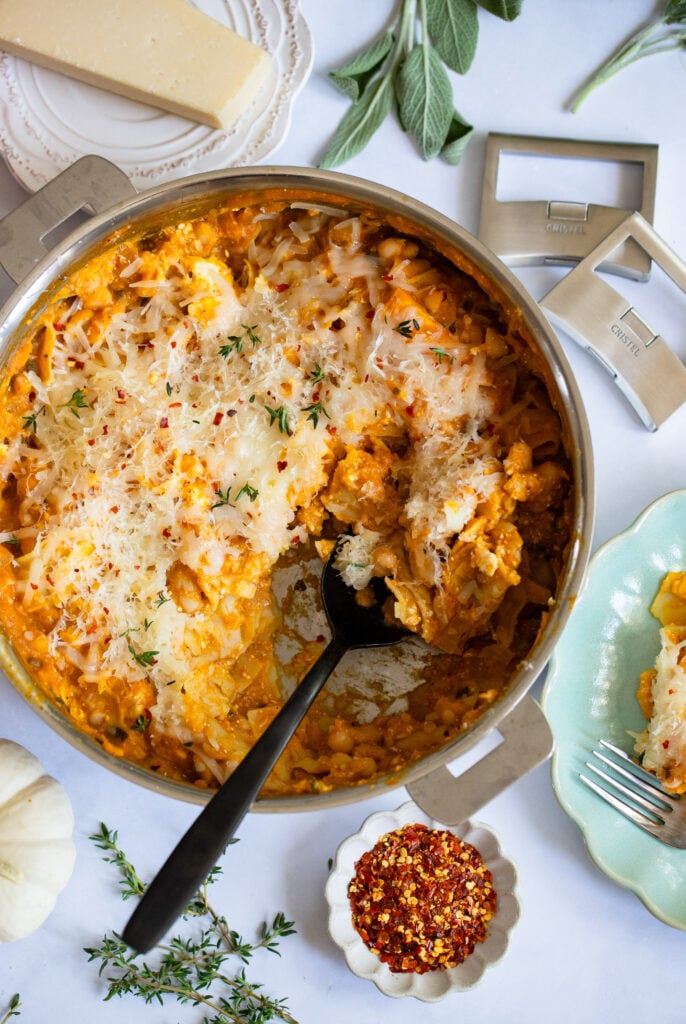 pumpkin skillet lasagna on a table with a serving spoon