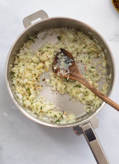 onion and herbs sautéed in a skillet