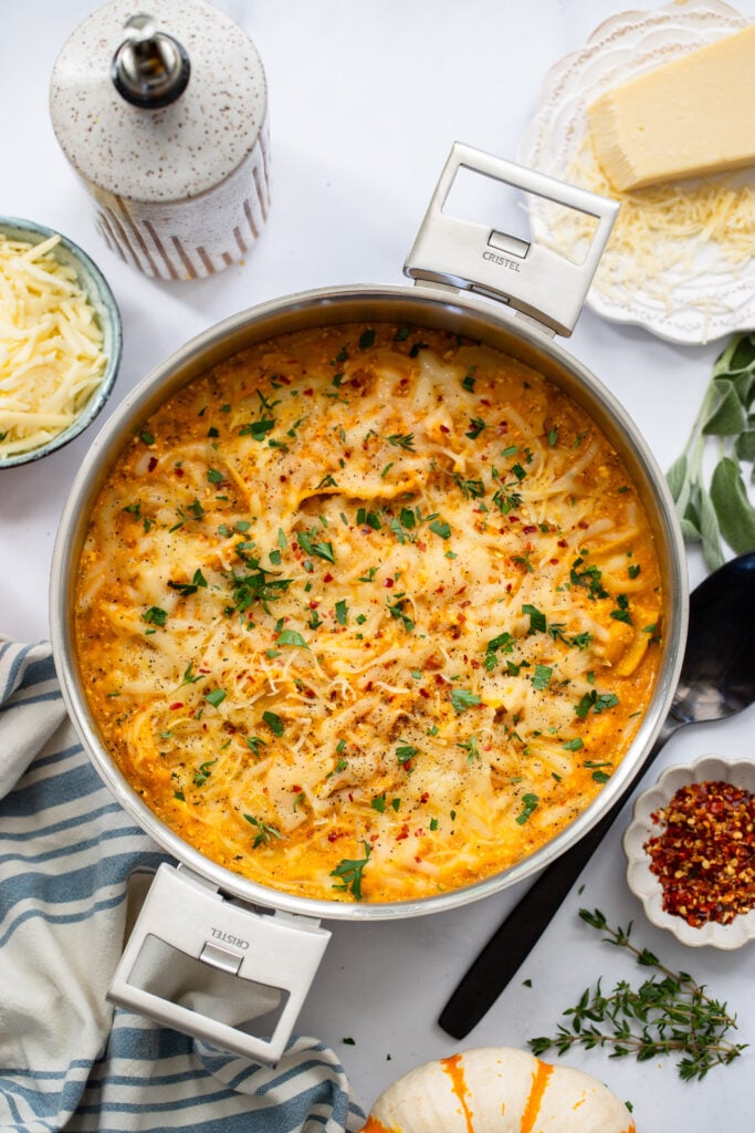 pumpkin skillet lasagna in skillet topped with fresh parsley