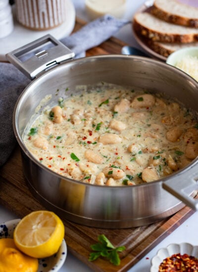 creamy butter beans in a skillet with tall sides.
