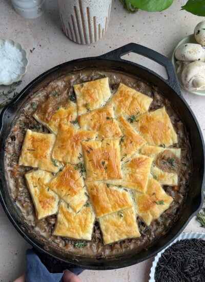 finished mushroom pot pie coming out of the oven with golden brown puff pastry on top. 
