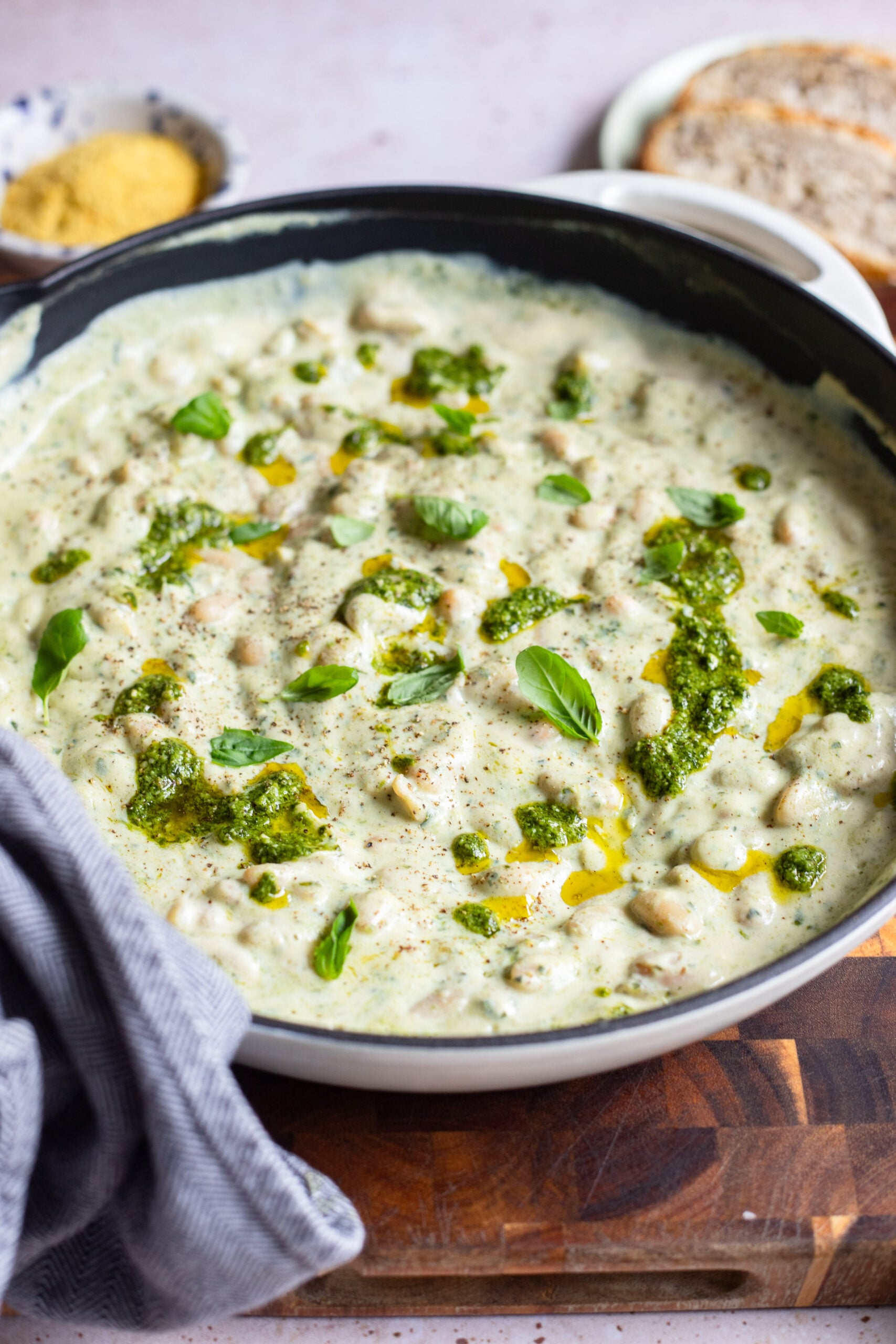 creamy pesto beans in a cast iron skillet