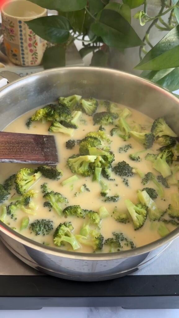 broccoli and creamy sauce simmering in a skillet