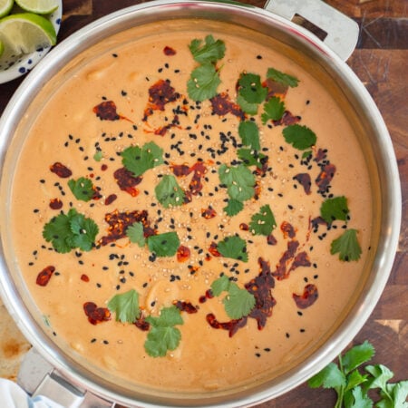 butter beans in a creamy peanut sauce in a skillet