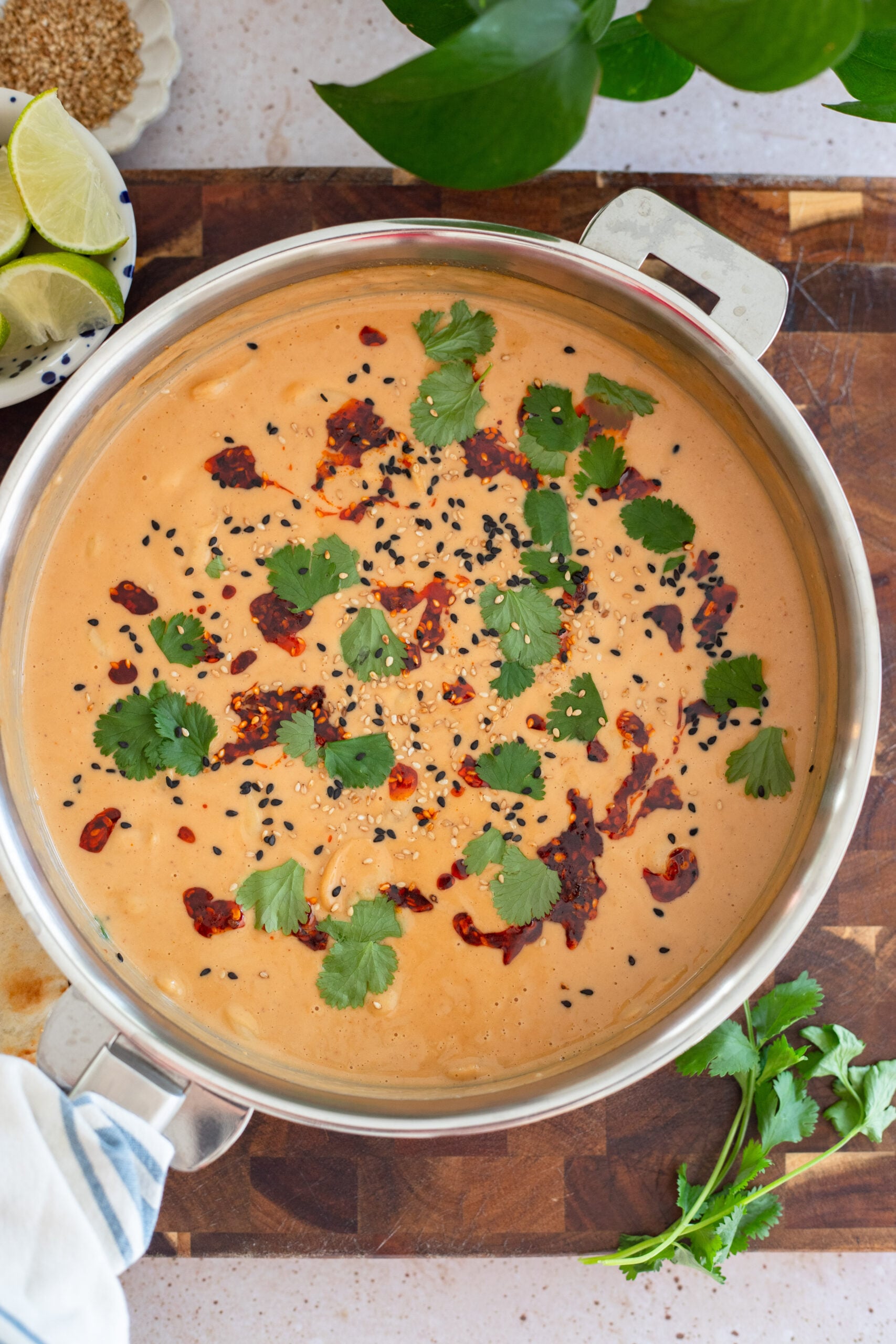 peanut sauce butter beans in a skillet with cilantro and chili crisp