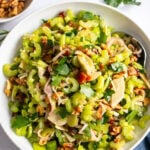 celery salad with parmesan, walnuts, and dates in a bowl