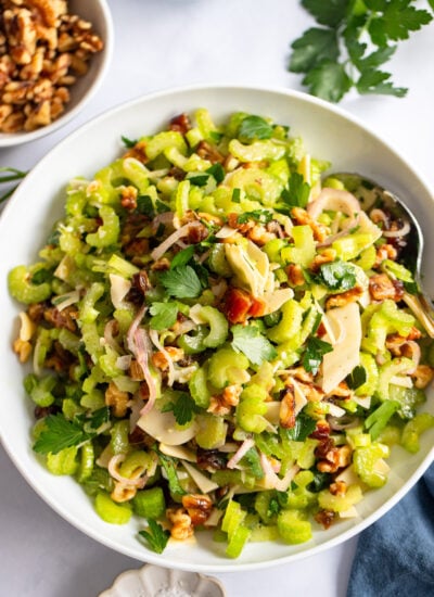 celery salad with parmesan, walnuts, and dates in a bowl
