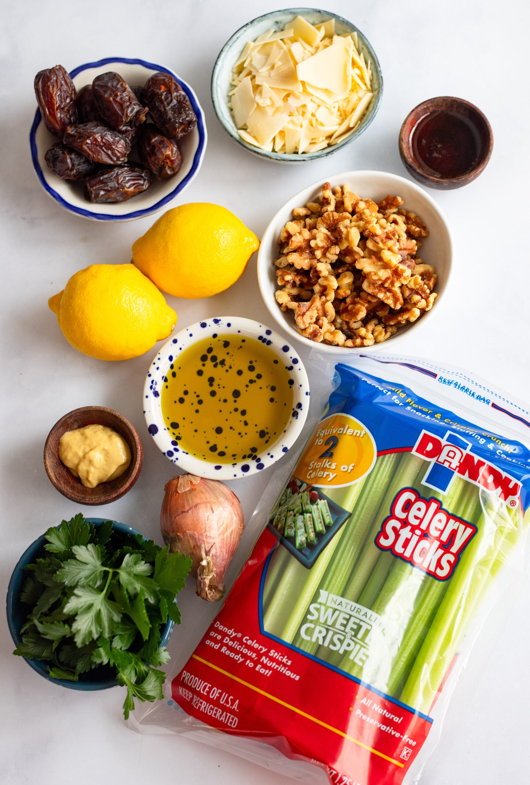 ingredients for celery salad with parmesan laid out on a white background