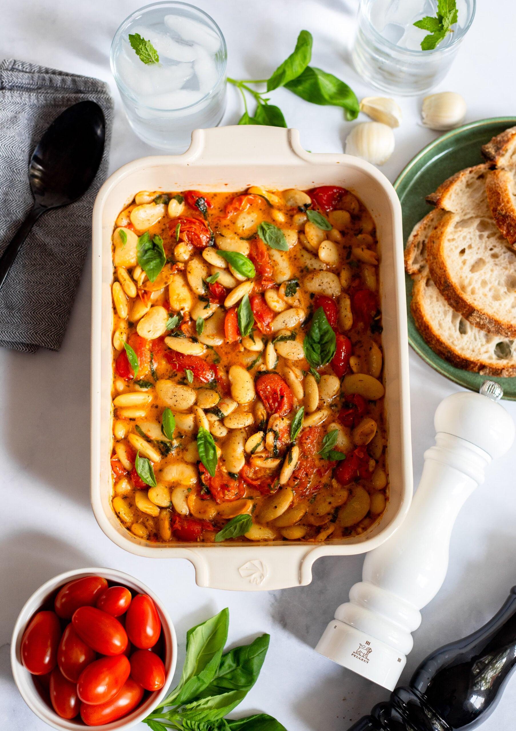 butter beans, feta, and tomatoes in a ceramic baking dish