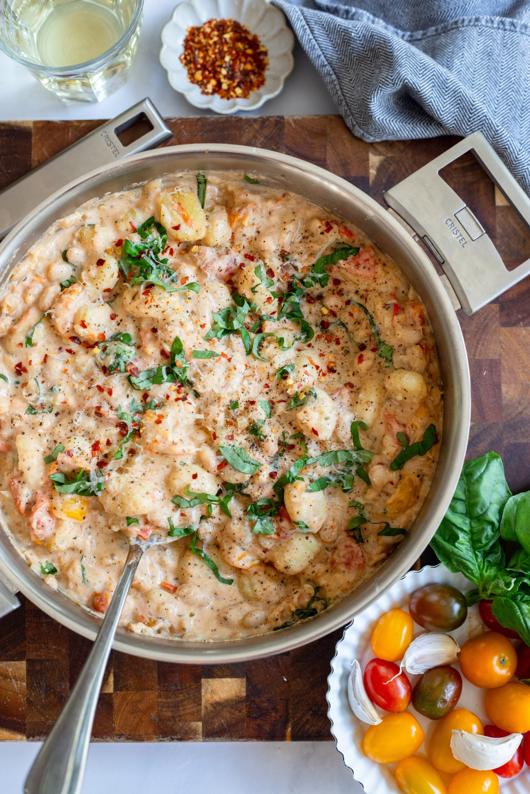 creamy tomato gnocchi in a skillet garnished with basil