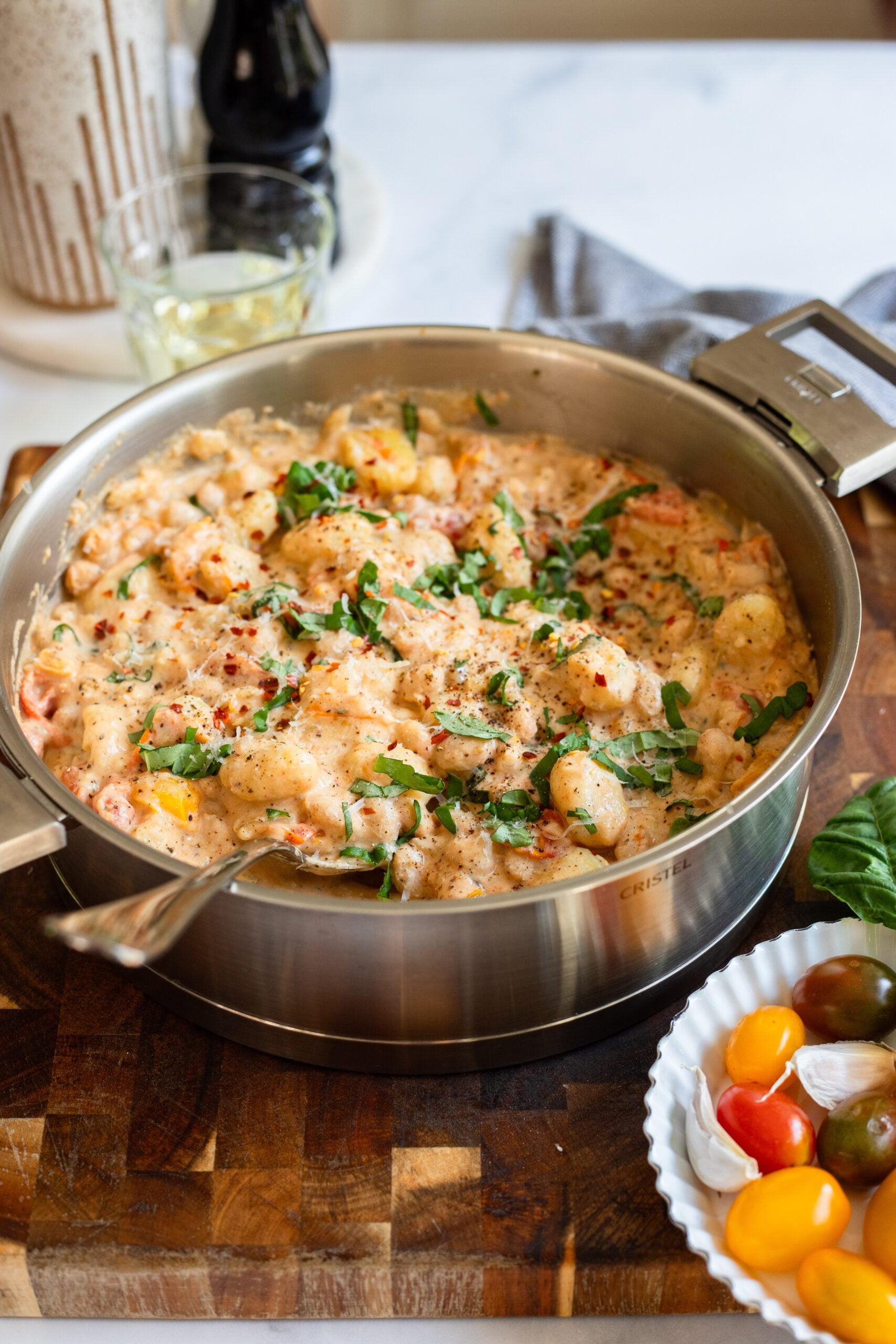creamy tomato gnocchi in a skillet with basil and parmesan