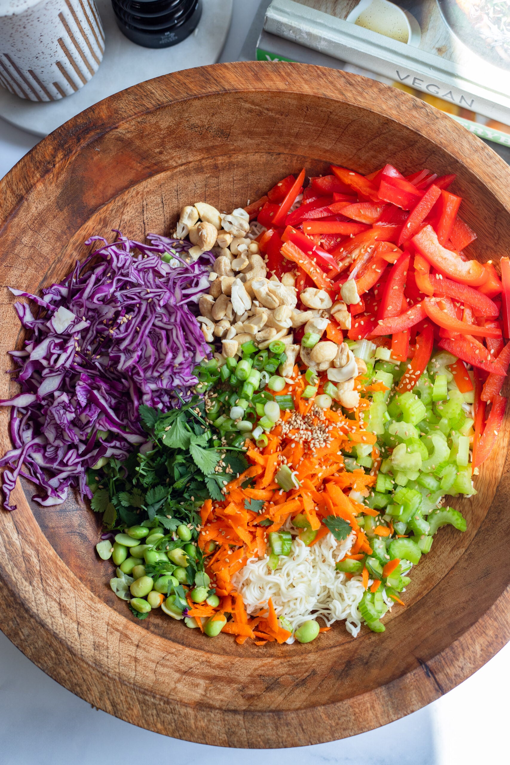 ramen noodle salad ingredients in a large wooden serving bowl