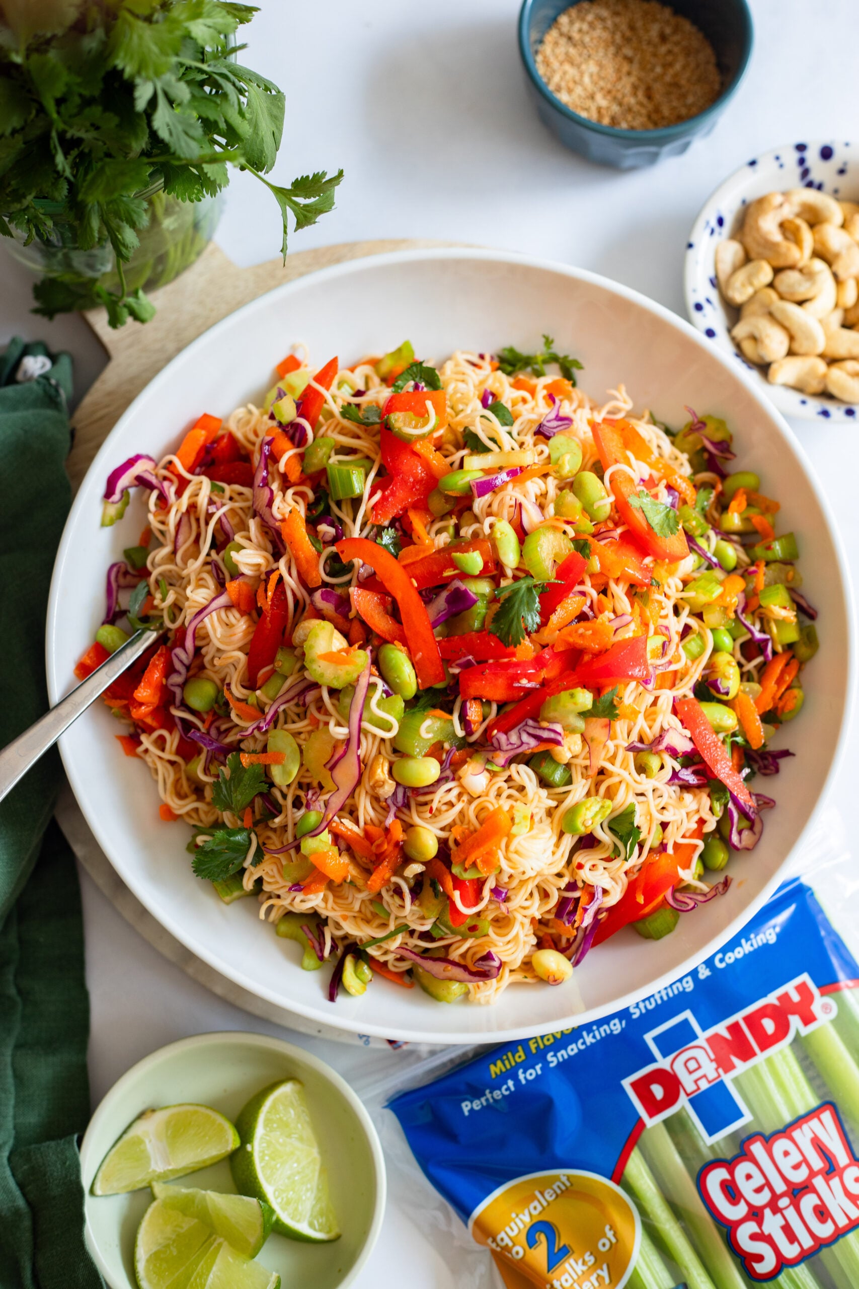 cold ramen noodle salad garnished with cilantro in a white bowl
