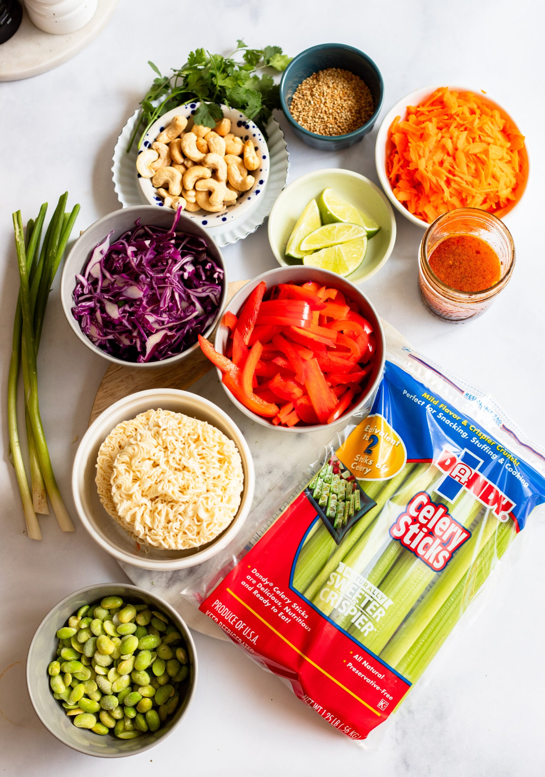 ramen noodle salad ingredients arranged on a white background